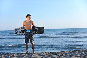 Image showing Portrait of a young  kitsurf  man at beach on sunset