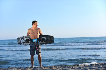 Image showing Portrait of a young  kitsurf  man at beach on sunset