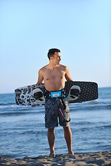 Image showing Portrait of a young  kitsurf  man at beach on sunset