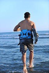 Image showing Portrait of a young  kitsurf  man at beach on sunset