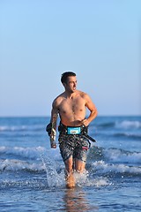 Image showing Portrait of a young  kitsurf  man at beach on sunset