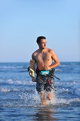 Image showing Portrait of a young  kitsurf  man at beach on sunset