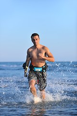 Image showing Portrait of a young  kitsurf  man at beach on sunset