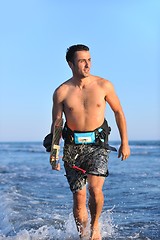 Image showing Portrait of a young  kitsurf  man at beach on sunset