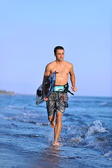 Image showing Portrait of a young  kitsurf  man at beach on sunset