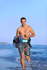 Image showing Portrait of a young  kitsurf  man at beach on sunset