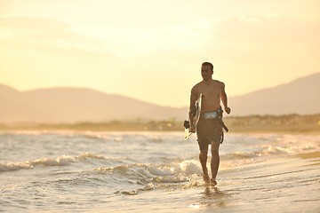 Image showing Portrait of a young  kitsurf  man at beach on sunset