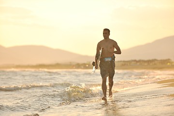 Image showing Portrait of a young  kitsurf  man at beach on sunset