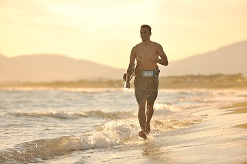 Image showing Portrait of a young  kitsurf  man at beach on sunset