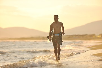 Image showing Portrait of a young  kitsurf  man at beach on sunset