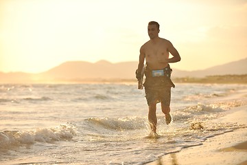 Image showing Portrait of a young  kitsurf  man at beach on sunset