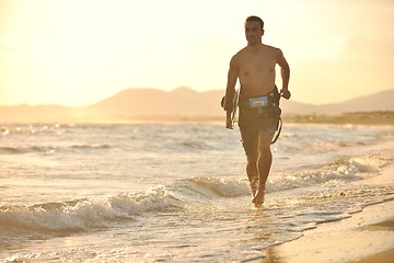 Image showing Portrait of a young  kitsurf  man at beach on sunset