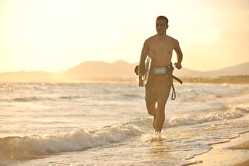 Image showing Portrait of a young  kitsurf  man at beach on sunset