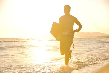 Image showing Portrait of a young  kitsurf  man at beach on sunset