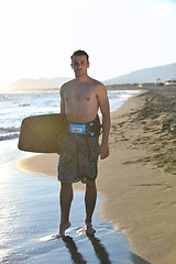 Image showing Portrait of a young  kitsurf  man at beach on sunset