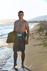 Image showing Portrait of a young  kitsurf  man at beach on sunset