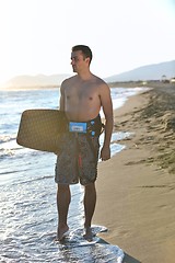 Image showing Portrait of a young  kitsurf  man at beach on sunset