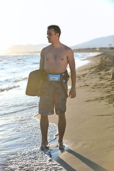 Image showing Portrait of a young  kitsurf  man at beach on sunset