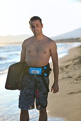 Image showing Portrait of a young  kitsurf  man at beach on sunset