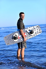 Image showing Portrait of a young  kitsurf  man at beach on sunset