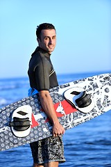 Image showing Portrait of a young  kitsurf  man at beach on sunset