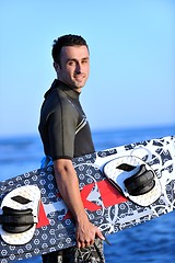 Image showing Portrait of a young  kitsurf  man at beach on sunset