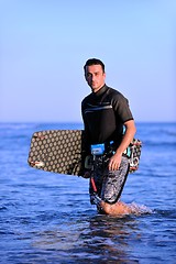 Image showing Portrait of a young  kitsurf  man at beach on sunset