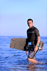 Image showing Portrait of a young  kitsurf  man at beach on sunset