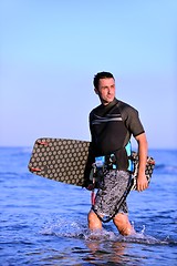 Image showing Portrait of a young  kitsurf  man at beach on sunset