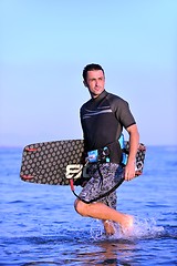 Image showing Portrait of a young  kitsurf  man at beach on sunset