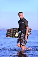 Image showing Portrait of a young  kitsurf  man at beach on sunset