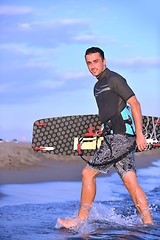 Image showing Portrait of a young  kitsurf  man at beach on sunset