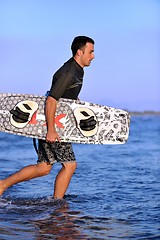 Image showing Portrait of a young  kitsurf  man at beach on sunset