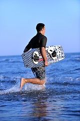 Image showing Portrait of a young  kitsurf  man at beach on sunset