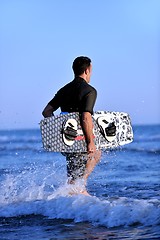 Image showing Portrait of a young  kitsurf  man at beach on sunset