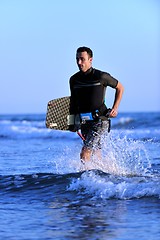 Image showing Portrait of a young  kitsurf  man at beach on sunset