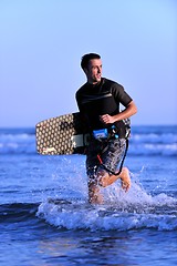 Image showing Portrait of a young  kitsurf  man at beach on sunset