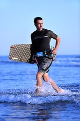 Image showing Portrait of a young  kitsurf  man at beach on sunset