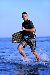 Image showing Portrait of a young  kitsurf  man at beach on sunset