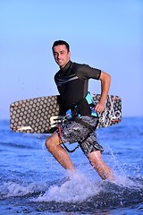 Image showing Portrait of a young  kitsurf  man at beach on sunset