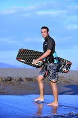 Image showing Portrait of a young  kitsurf  man at beach on sunset