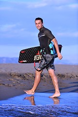 Image showing Portrait of a young  kitsurf  man at beach on sunset