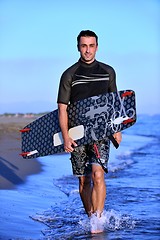 Image showing Portrait of a young  kitsurf  man at beach on sunset