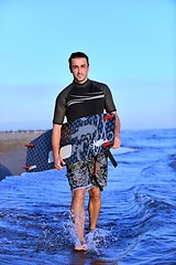 Image showing Portrait of a young  kitsurf  man at beach on sunset