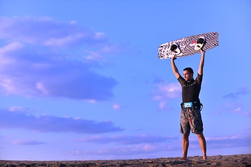 Image showing Portrait of a young  kitsurf  man at beach on sunset