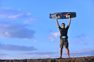 Image showing Portrait of a young  kitsurf  man at beach on sunset