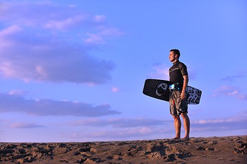 Image showing Portrait of a young  kitsurf  man at beach on sunset