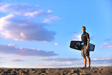 Image showing Portrait of a young  kitsurf  man at beach on sunset