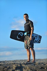 Image showing Portrait of a young  kitsurf  man at beach on sunset