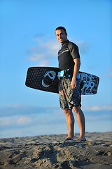 Image showing Portrait of a young  kitsurf  man at beach on sunset